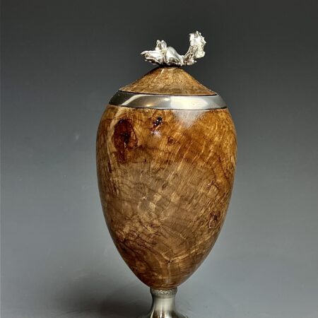 Cherry burl and pewter.