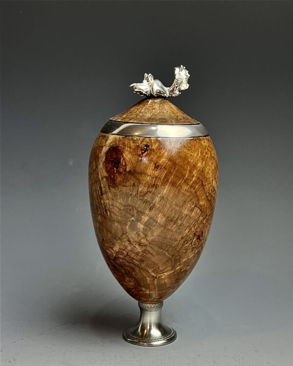 Cherry burl and pewter.